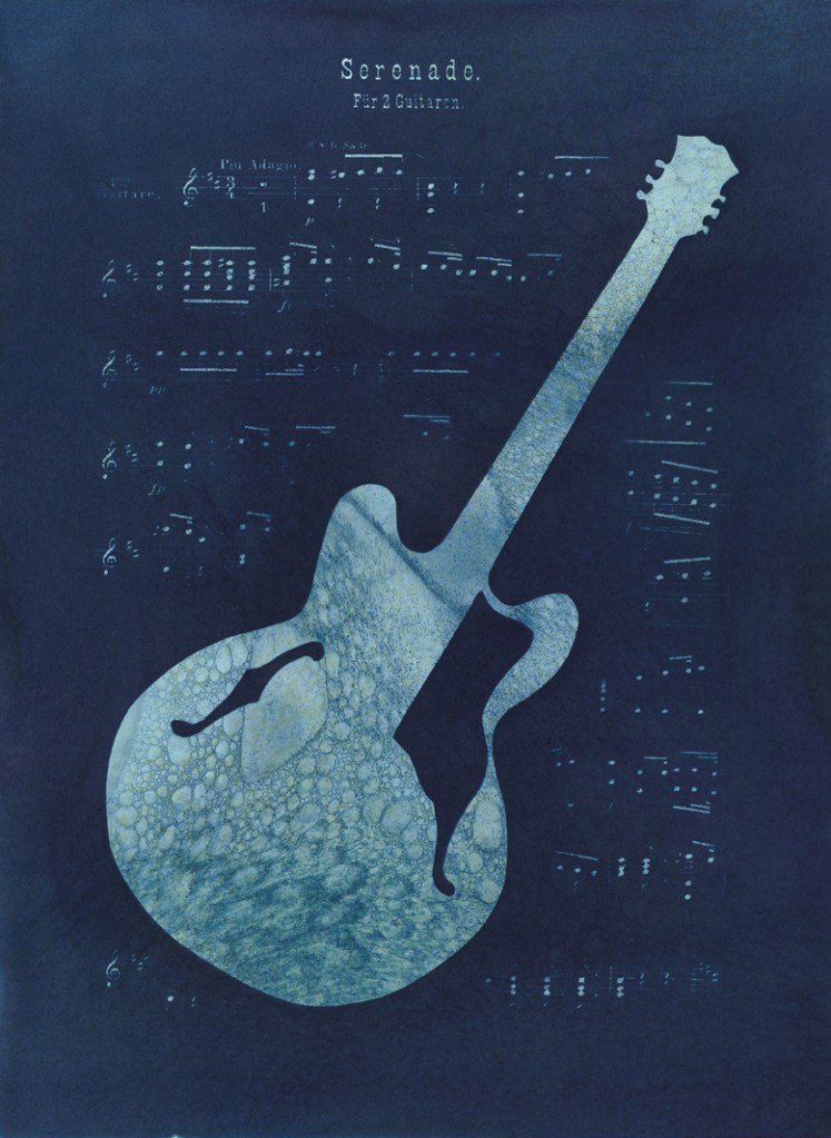 Double exposure cyanotype print of a guitar with sheet music. Commission piece by Jill Welham