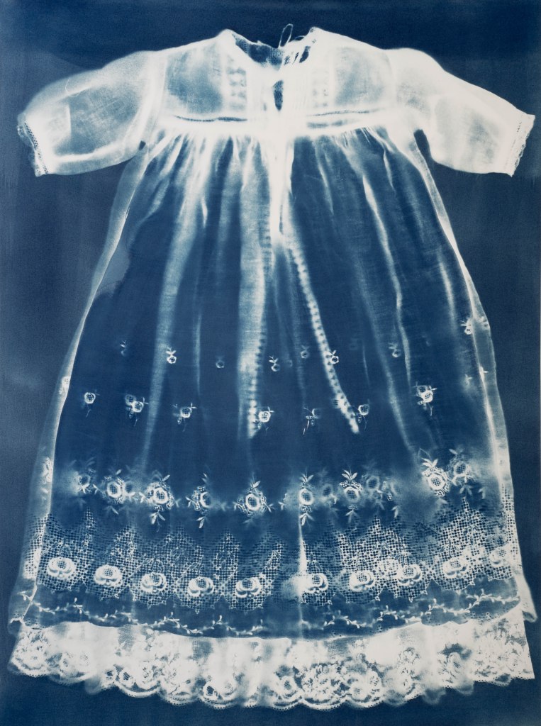 Blue and white cyanotype photogram of a babies christening gown. Commission work by Jill Welham.